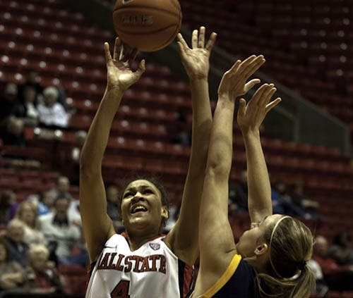 Ball State freshman, Nathalie Fontaine aids her team in a tough win against Kent State with a lay up, guarded by Kent State’s Tamzin Barroilhet. Ball State will play tonight against Central Michigan. DN FILE PHOTO RJ RICKER