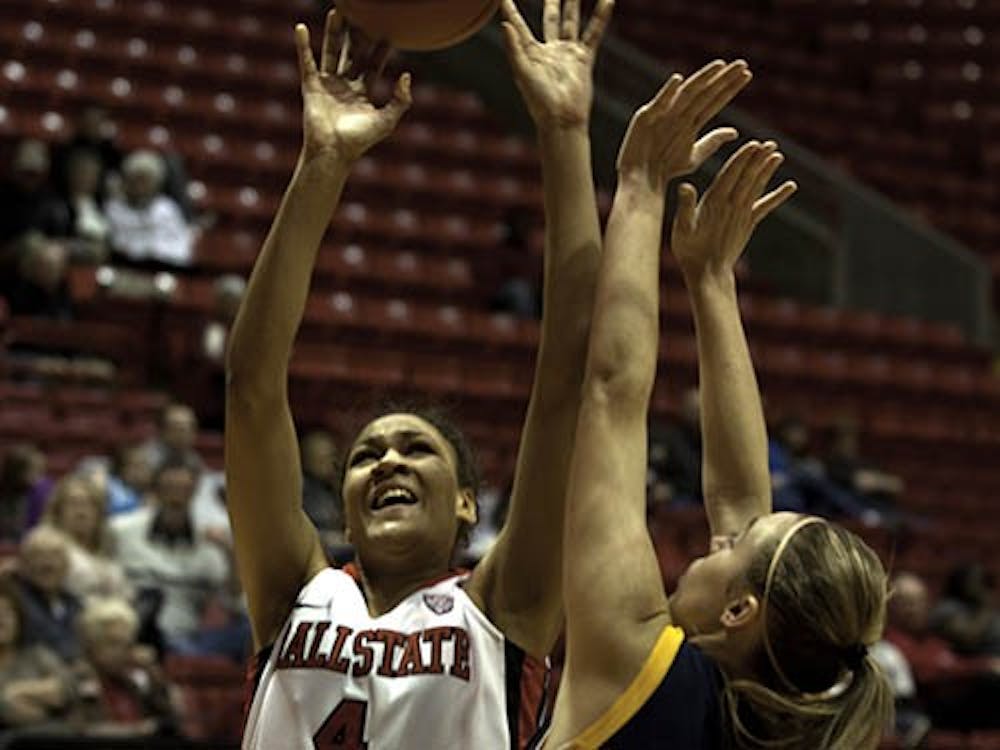 Ball State freshman, Nathalie Fontaine aids her team in a tough win against Kent State with a lay up, guarded by Kent State’s Tamzin Barroilhet. Ball State will play tonight against Central Michigan. DN FILE PHOTO RJ RICKER