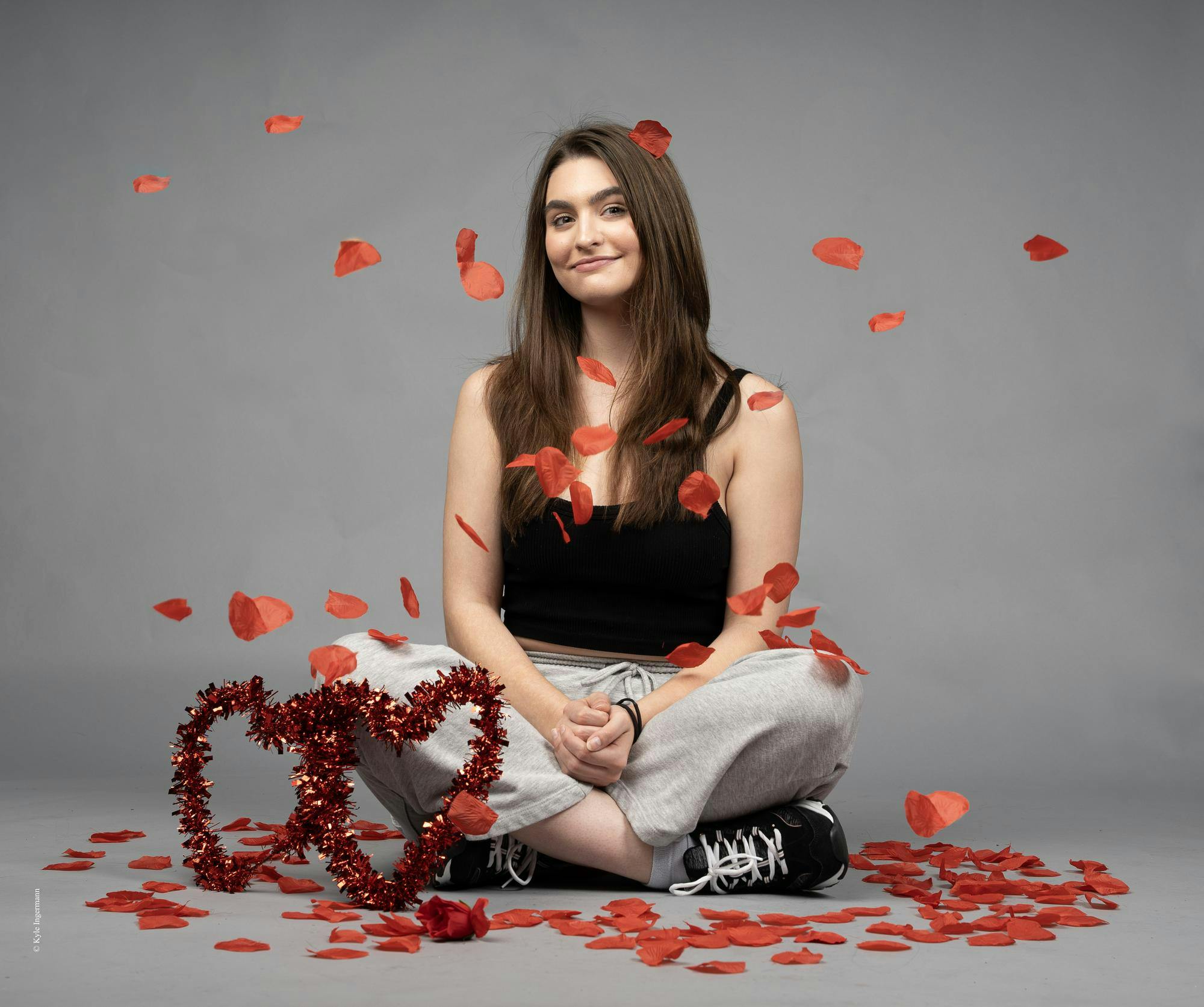 Junior Jayden Vaughn poses surrounded by roses for their opinion piece ‘Love on My Time’ Nov. 12 at Ball State University. Kyle Ingermann, DN Photo Illustration