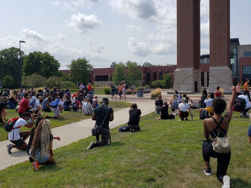 Demonstrators kneel for 8 minutes and 42 seconds in memory of George Floyd at the University Green Tuesday Afternoon. The protest, which was organized by Ball State senior public communications major Taylor Hall, was attended by nearly 100 protesters. John Lynch, DN