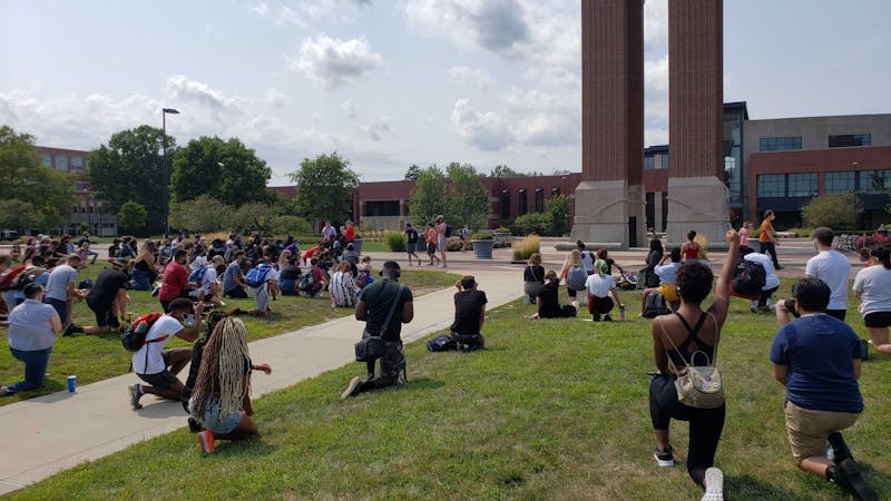 Demonstrators kneel for 8 minutes and 42 seconds in memory of George Floyd at the University Green Tuesday Afternoon. The protest, which was organized by Ball State senior public communications major Taylor Hall, was attended by nearly 100 protesters. John Lynch, DN