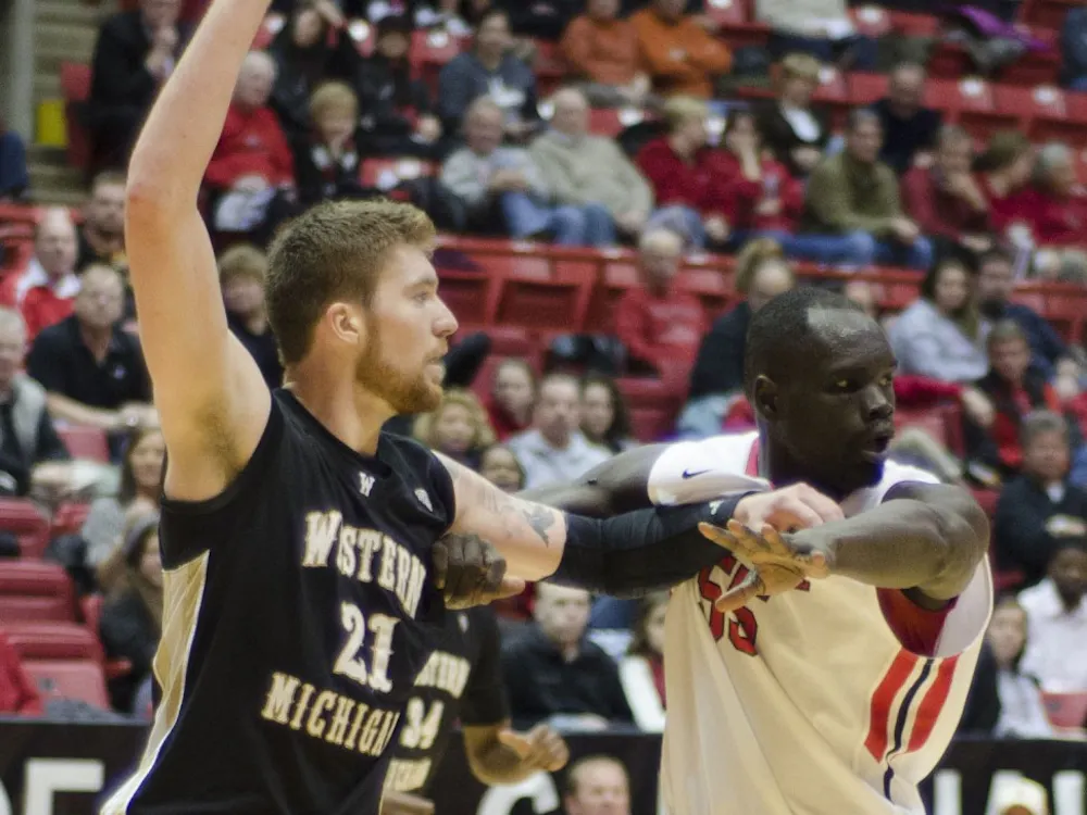 Senior center Majok Majok tries to block Western Michigan player Shayne Whittington in the second half Feb. 26 at Worthen Arena. DN PHOTO AUDREY ADDINGTON
