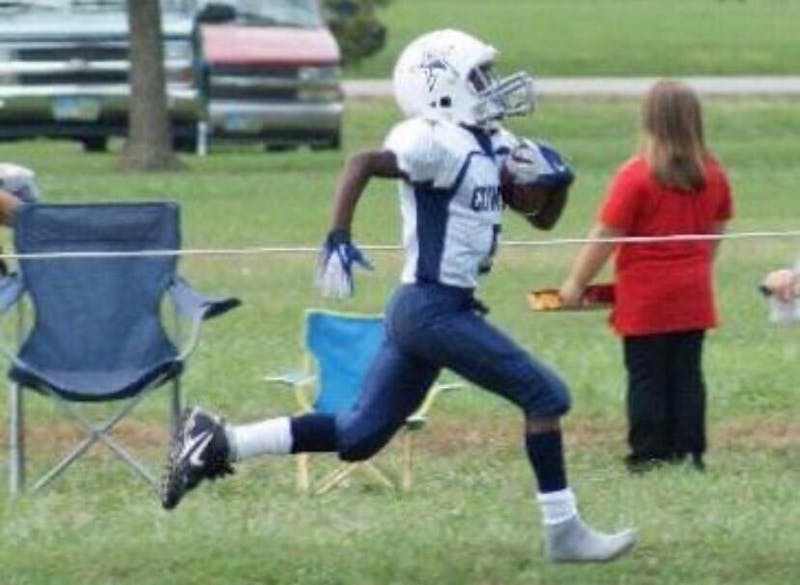 Growing up playing multiple sports, freshman wide receiver Qian Magwood runs the ball in 2014 while playing youth football. He continued his football career throughout high school before arriving at Ball State. Qian Magwood, photo provided. 