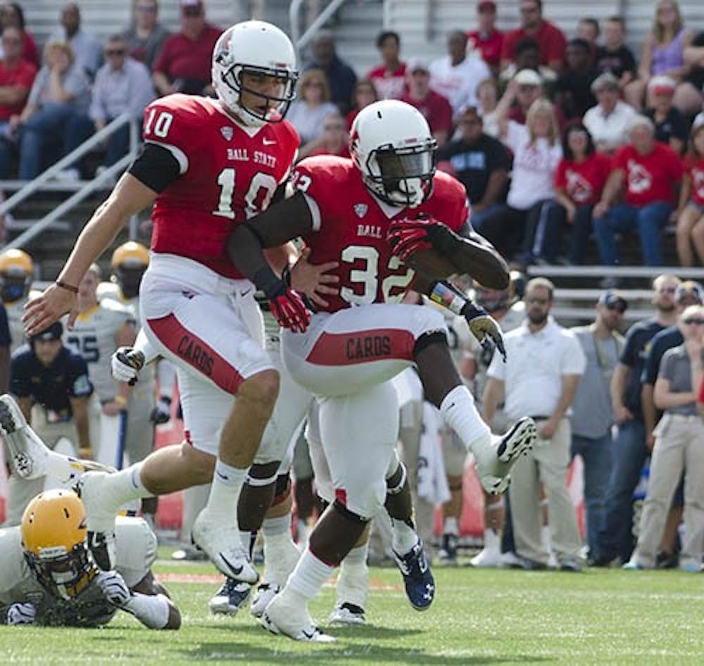 Senior quarterback Keith Wenning, left, runs in with junior running back Jahwan Edwards for a touchdown against the University of Toledo on Sept. 28 at Scheumann Stadium. Edwards scored three touchdowns during the win. DN PHOTO BREANNA DAUGHERTY