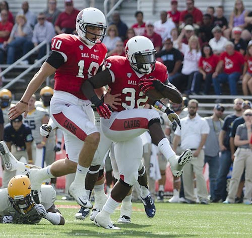 Senior quarterback Keith Wenning, left, runs in with junior running back Jahwan Edwards for a touchdown against the University of Toledo on Sept. 28 at Scheumann Stadium. Edwards scored three touchdowns during the win. DN PHOTO BREANNA DAUGHERTY