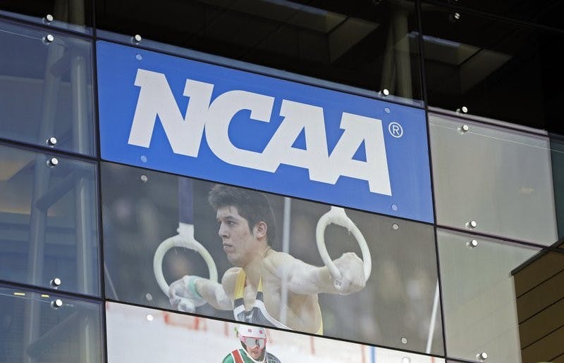 In this April 25, 2018, file photo, the NCAA headquarters is shown in Indianapolis. The NCAA is expected to approve a recommendation to all athletes who compete in fall sports, including football, over the next 10 months to not be charged a year of eligibility. It&#x27;s great news for current players, but comes with some complications for teams, coaches and future college football players. (AP Photo/Darron Cummings, File)