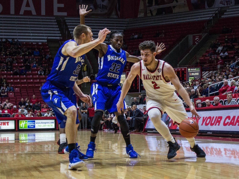 Ball State's guard Tayler Persons attempts to push past Indiana State's players during the game on Nov. 15 in Worthen Arena. The Cardinals lost 74-80. Grace Ramey // DN