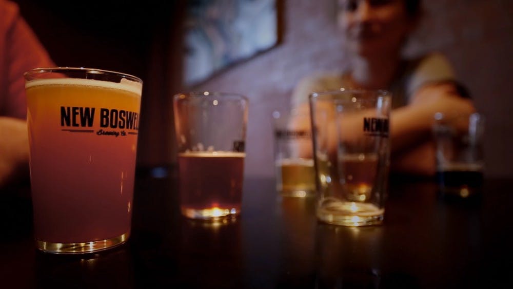 Three customers drink at New Boswell Brewery Company in Richmond, Ind., during the filming of 