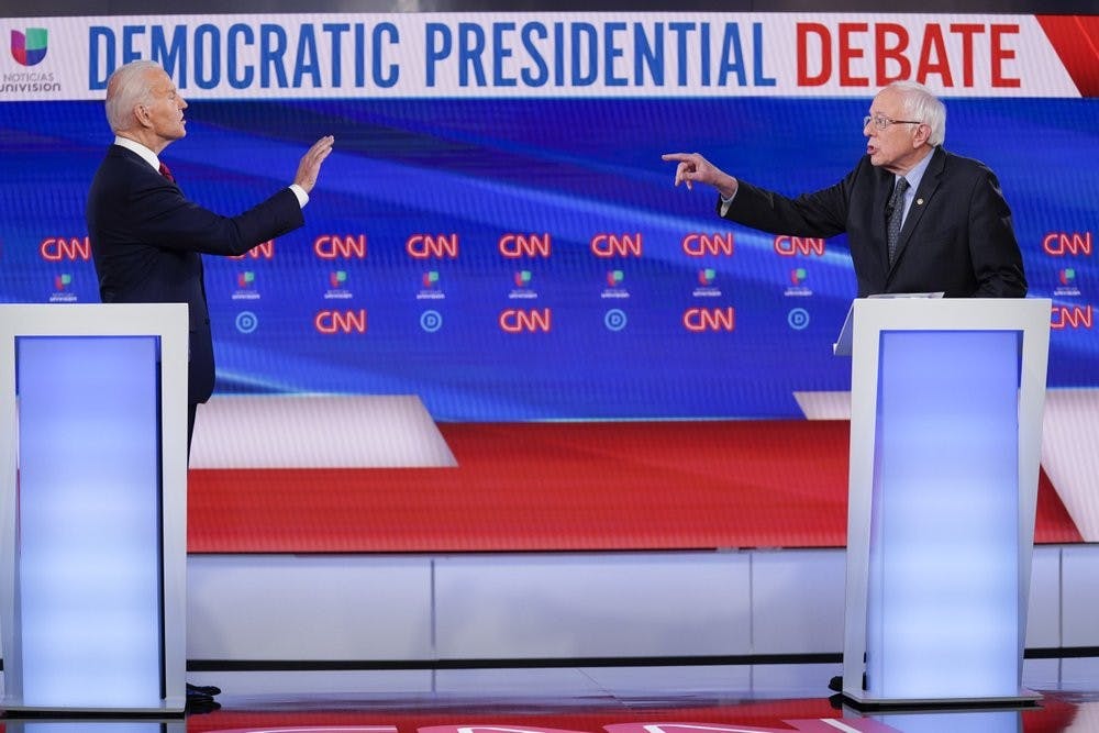 Former Vice President Joe Biden, left, and Sen. Bernie Sanders, I-Vt., right, participate in a Democratic presidential primary debate at CNN Studios in Washington, Sunday, March 15, 2020. (AP Photo/Evan Vucci)
