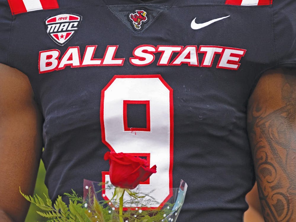 Senior linebacker Kieonte Newson holds a rose for his mother during senior day Nov. 23 at Scheumann Stadium. Newson remembered feeling a sense of restoration when he earned the number nine ahead of his third year as a Cardinal. Titus Slaughter, DN
