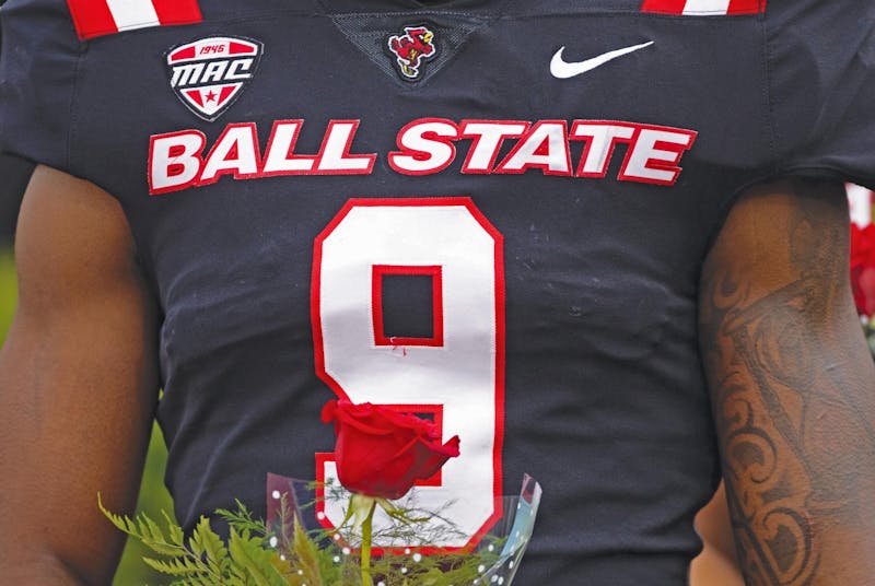 Senior linebacker Kieonte Newson holds a rose for his mother during senior day Nov. 23 at Scheumann Stadium. Newson remembered feeling a sense of restoration when he earned the number nine ahead of his third year as a Cardinal. Titus Slaughter, DN 
