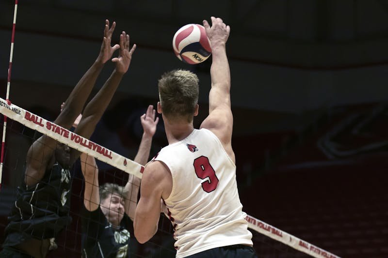 Fourth-year outside hitter Bryce Behrendt hits the ball over the net in a game against Quincy March 24 at Worthen Arena. Behrendt had seven digs in the game. Mya Cataline, DN