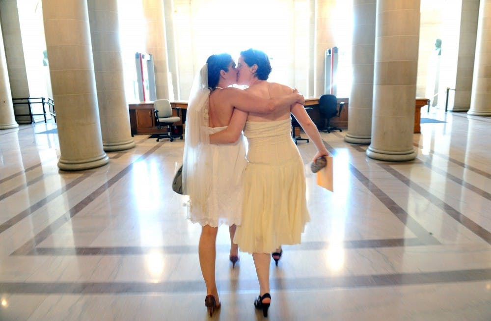 Cynthia Wides, left, and and Elizabeth Carey, of Oakland, California, walk out of City Hall a married couple in San Francisco, California, Saturday, June 29, 2013. MCT PHOTO