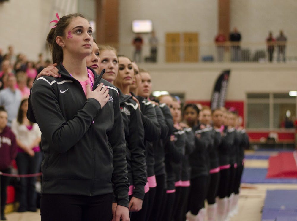 The Ball State gymnastics team listens to the National Anthem before the match against Kent State on Feb. 21 at Irving Gym. DN PHOTO BREANNA DAUGHERTY 