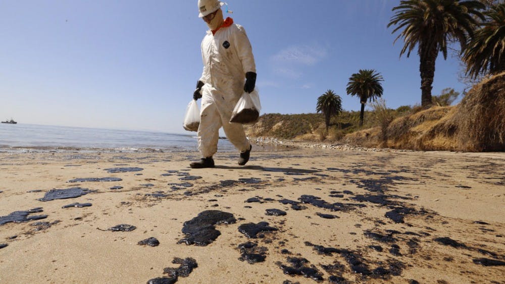 Crews from West Coast Environmental bag oiled sand on the beach as a cleanup operation began at Refugio State Beach on Wednesday morning. Photo by Al Seib / Los Angeles Times