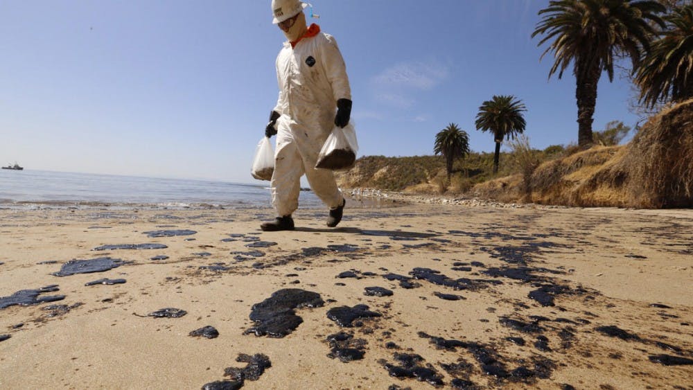 <p>Crews from West Coast Environmental bag oiled sand on the beach as a cleanup operation began at Refugio State Beach on Wednesday morning. Photo by Al Seib / Los Angeles Times</p>