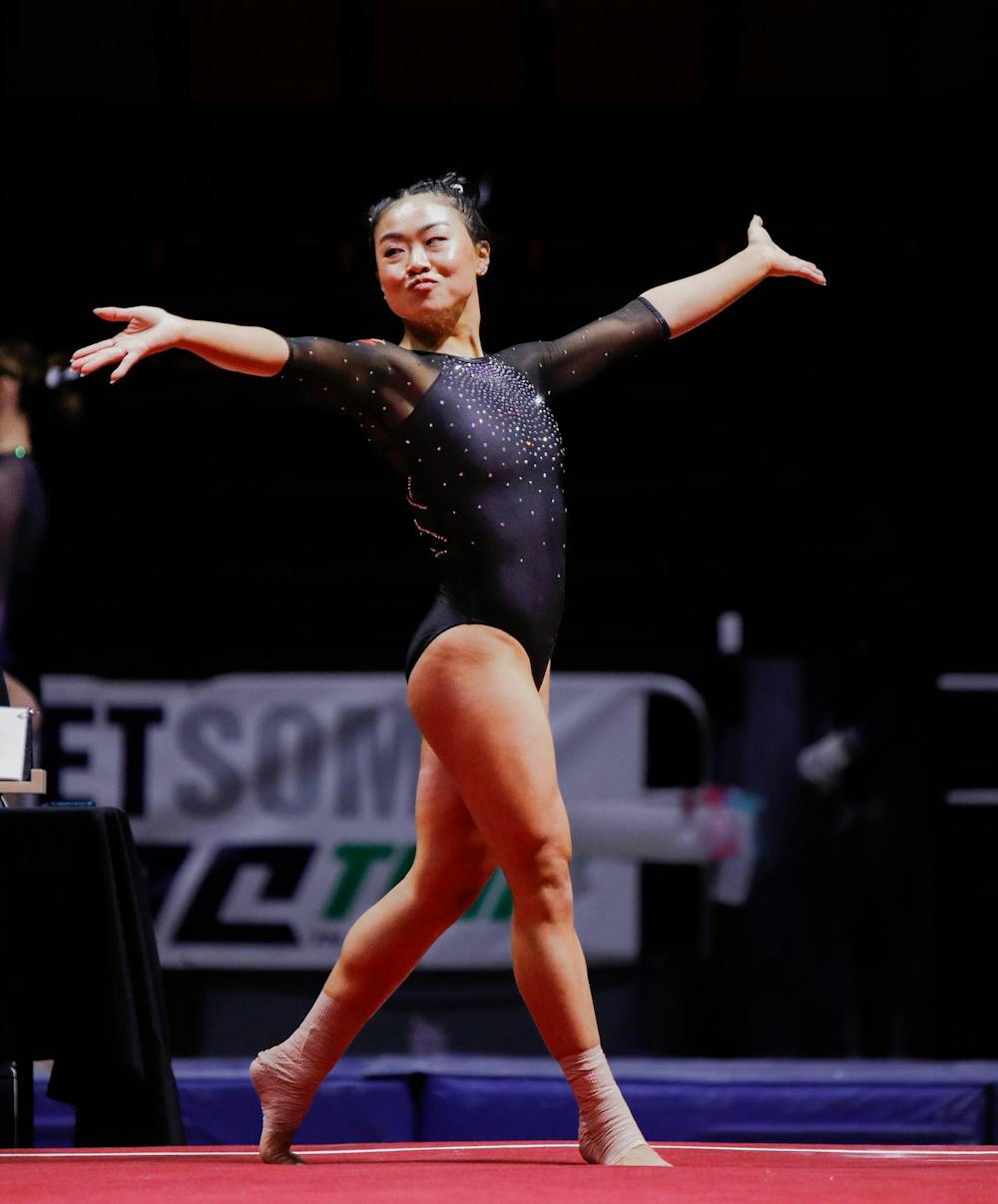 Senior all-around Suki Pfister strikes a pose during her floor routine March 23 at the Mid-American Championship at Worthen Arena. Pfister scored a 9.900 for her floor excersise. Andrew Berger, DN
