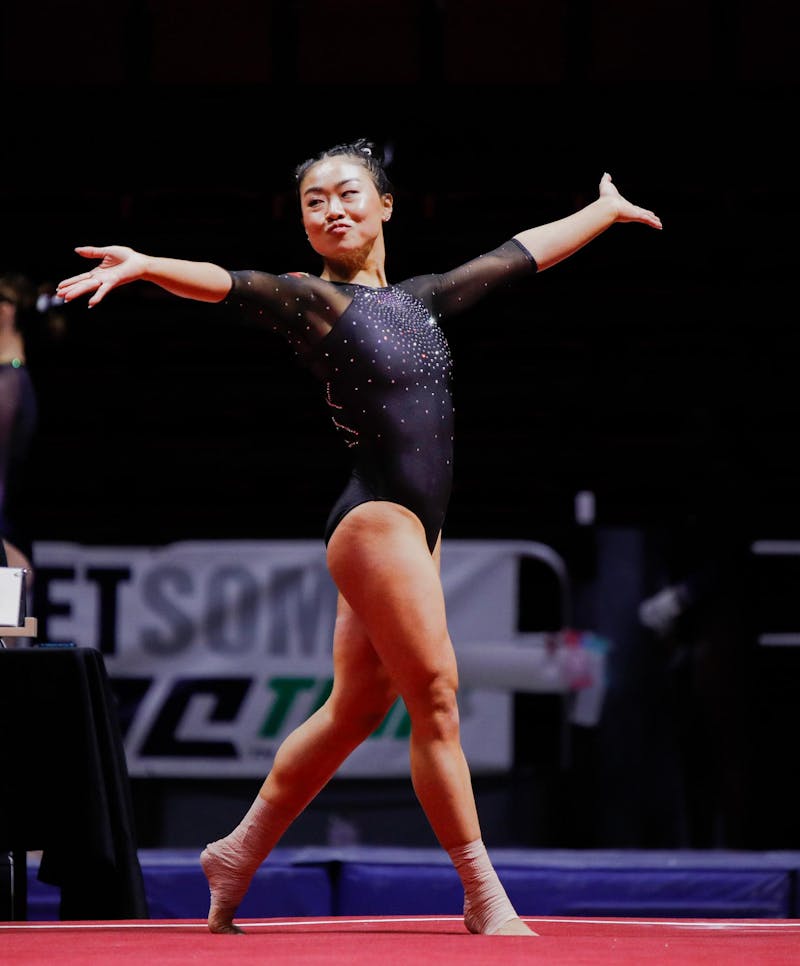Senior all-around Suki Pfister strikes a pose during her floor routine March 23 at the Mid-American Championship at Worthen Arena. Pfister scored a 9.900 for her floor excersise. Andrew Berger, DN