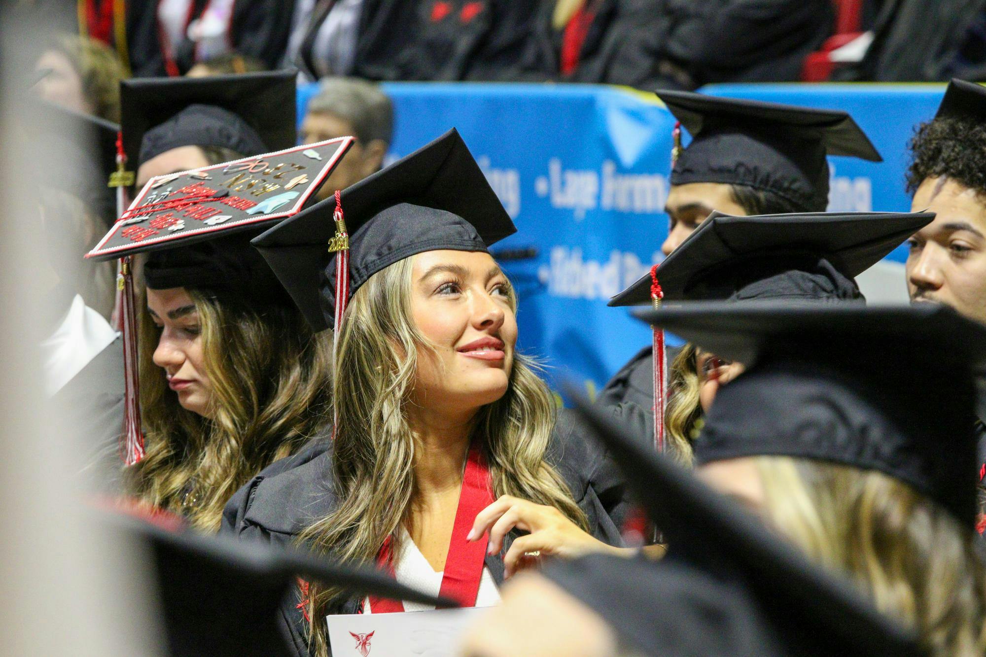 A graduate looks up to the crowd before walking at Fall Commencement Dec. 16 at Worthen Arena. Ball State conferred more than 1,200 doctoral, specialist, master’s and baccalaureate degrees during the ceremony. Daniel Kehn, DN