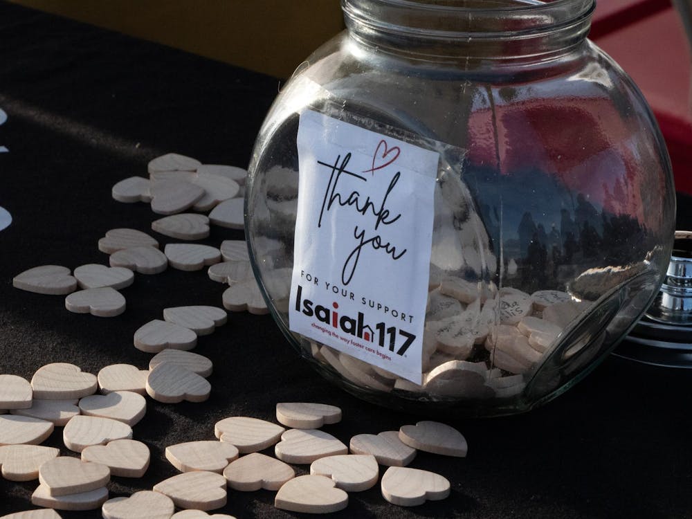 Attendees write their names on wooden hearts and place them into a jar. The event celebrated construction on the new location for Isaiah 117 House in Muncie. Abigail Denault, DN