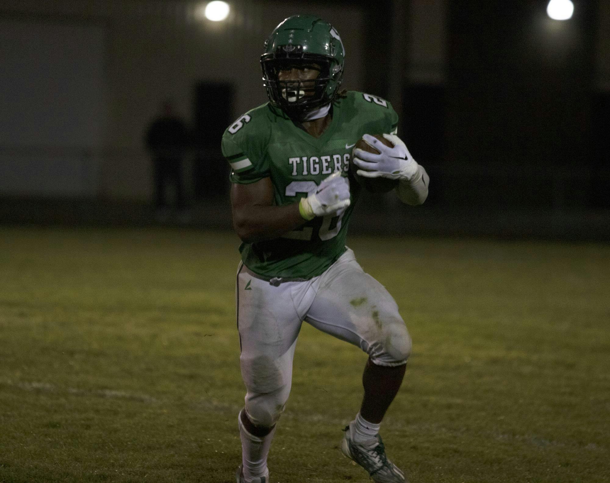 Senior Ayden Ewing begins to run September 15 during a game against New Castle. Zach Carter, DN. 