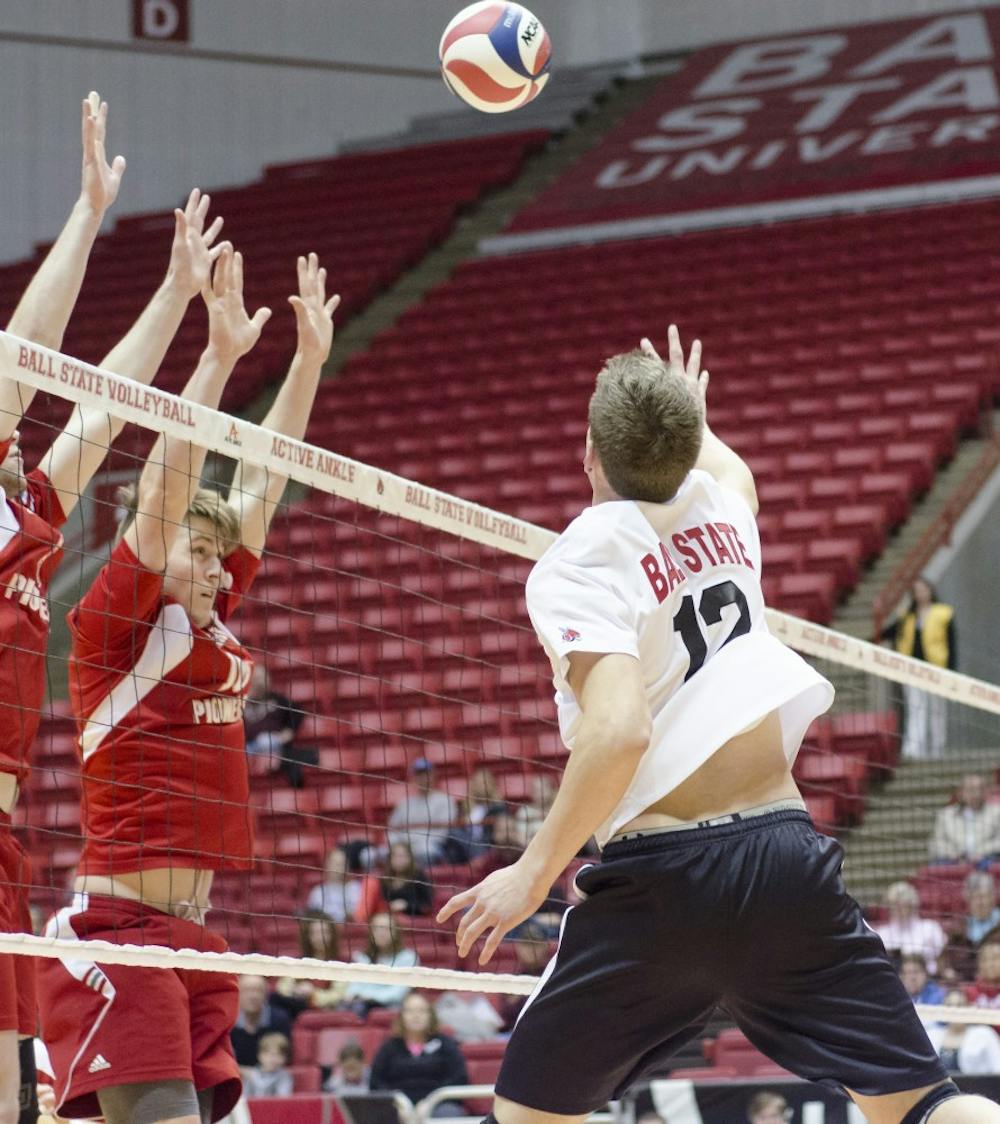 Junior outside attacker Matt Sutherland hits the ball over the net past Sacred Heart's defensive line. Ball State would go back and forth with Sacred Heart, but would take all three sets to win the game. DN PHOTO COREY OHLENKAMP