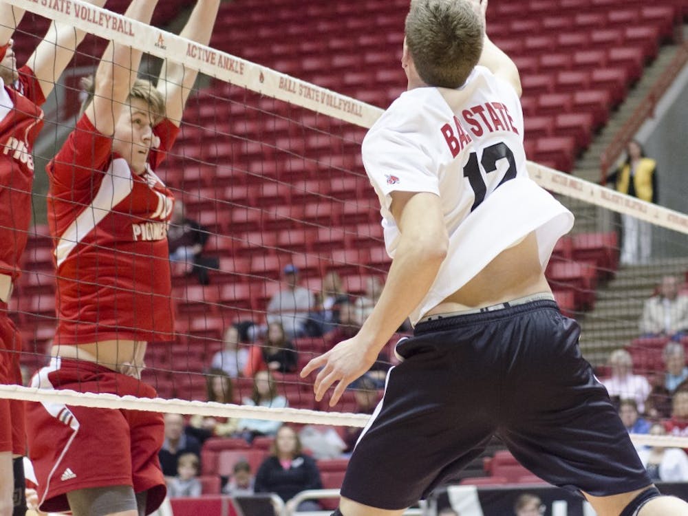 Junior outside attacker Matt Sutherland hits the ball over the net past Sacred Heart's defensive line. Ball State would go back and forth with Sacred Heart, but would take all three sets to win the game. DN PHOTO COREY OHLENKAMP