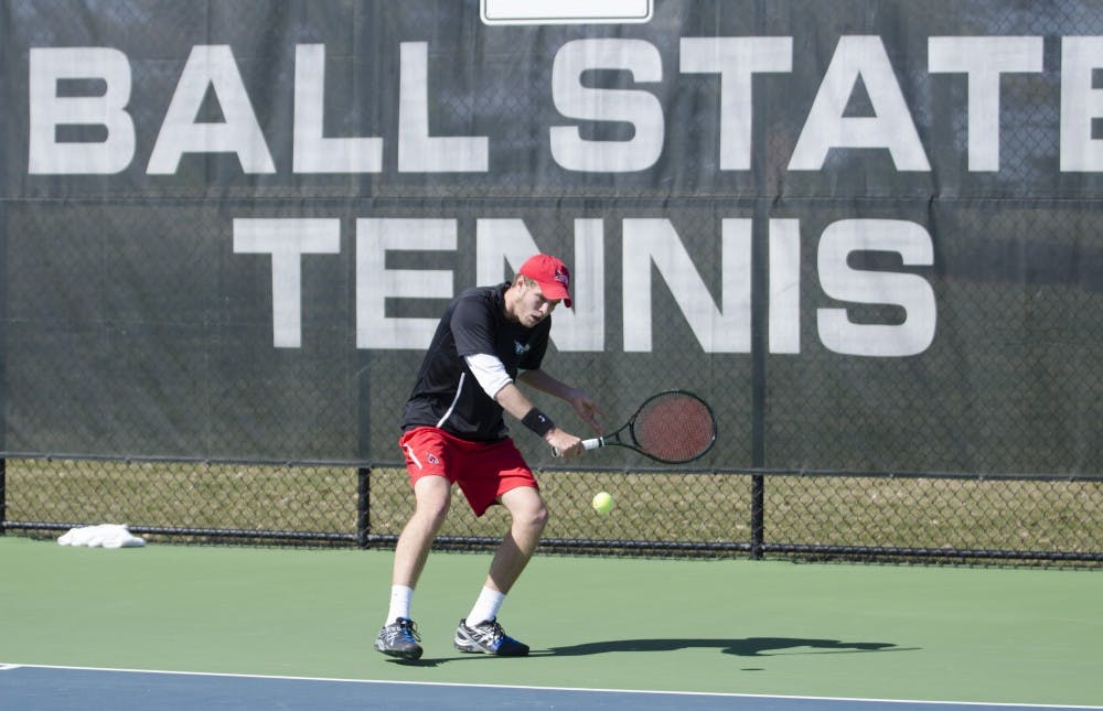 Freshman Patrick Downs hits the ball in his singles match against Toledo on March 30 at the Cardinal Creek Tennis Courts. DN PHOTO BREANNA DAUGHERTY