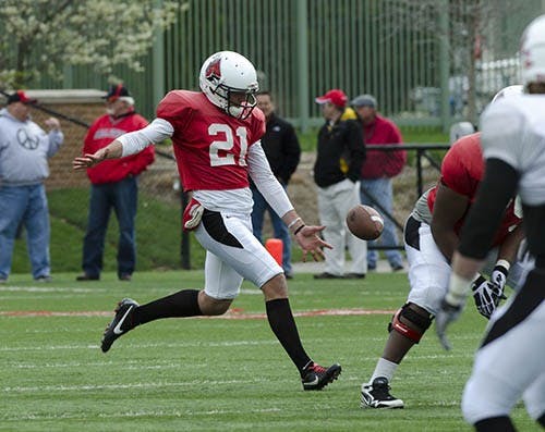 Kyle Schmidt punts the ball away for the Cardinal team. DN PHOTO COREY OHLENKAMP