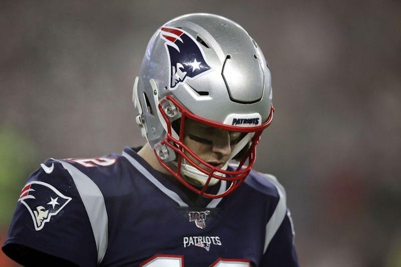 New England Patriots quarterback Tom Brady walks to the sideline after a series of plays in the first half of Saturday's wildcard loss to the Titans. (Telegram & Gazette, TNS)