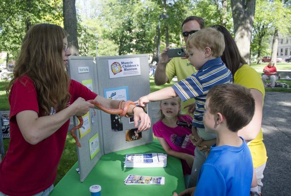 Cooper Swart, 1, touches a snake at the Muncie Children's Museum booth at the Festival of the Arts on June 14 at the Arts Terraces. DN PHOTO BREANNA DAUGHERTY 