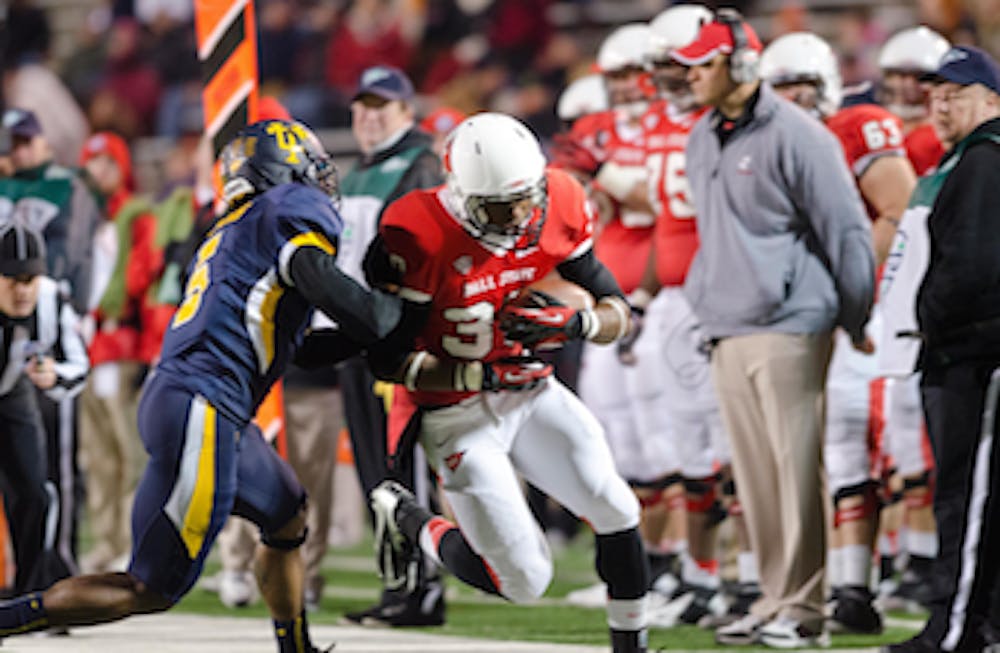 DN PHOTO COREY OHLENKAMP Sophomore running back Jahwan Edwards tries to slip the Toledo defender as he attempts a run for Ball State. Edwards broke 1,000 rushing yards for the season during the game against Toledo. He was the first Ball State running back to do so since 2008. 