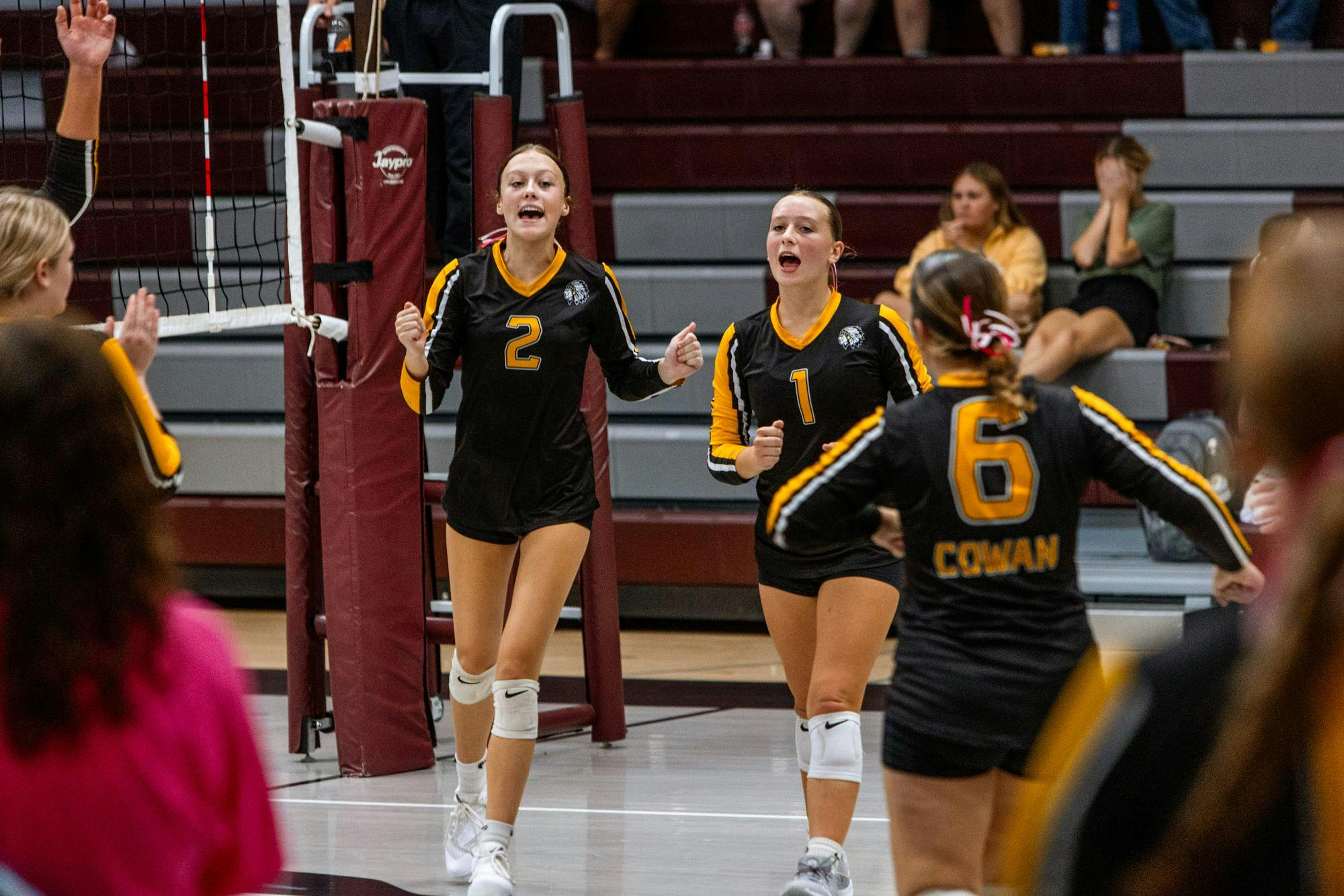 Junior, Brylynn Coon, and Freshman, Demi Abott cheer as Cowan gets a point in the third set. Cowan then won against the Wes-Del Warriors on Sept. 10 at Wes-Del Jr./Sr. High School. (Photo by Kaylee Kern) 
