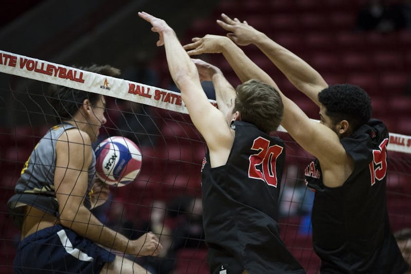 Junior outside hitter David Siebum and red shirted sophomore middle attacker Lem Turner pushes a kill back over the net against a Emmanuel Lions attacker, Jan. 6, at John E. Worthen Arena. Ball State swept the Lions, in three straight sets, 16-25, 15-25, 12-25. Grace Hollars, DN&nbsp;