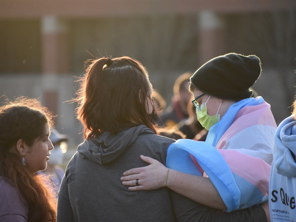 Chloee Bowne (left) and Ezra Dalton (right) hug one another after listening to several speakers at a rally against House Bill 1041 Feb. 1 at University Green. Dalton is a sophomore at Ball State and the treasurer of Ball State Spectrum. Grace Duerksen, DN  
