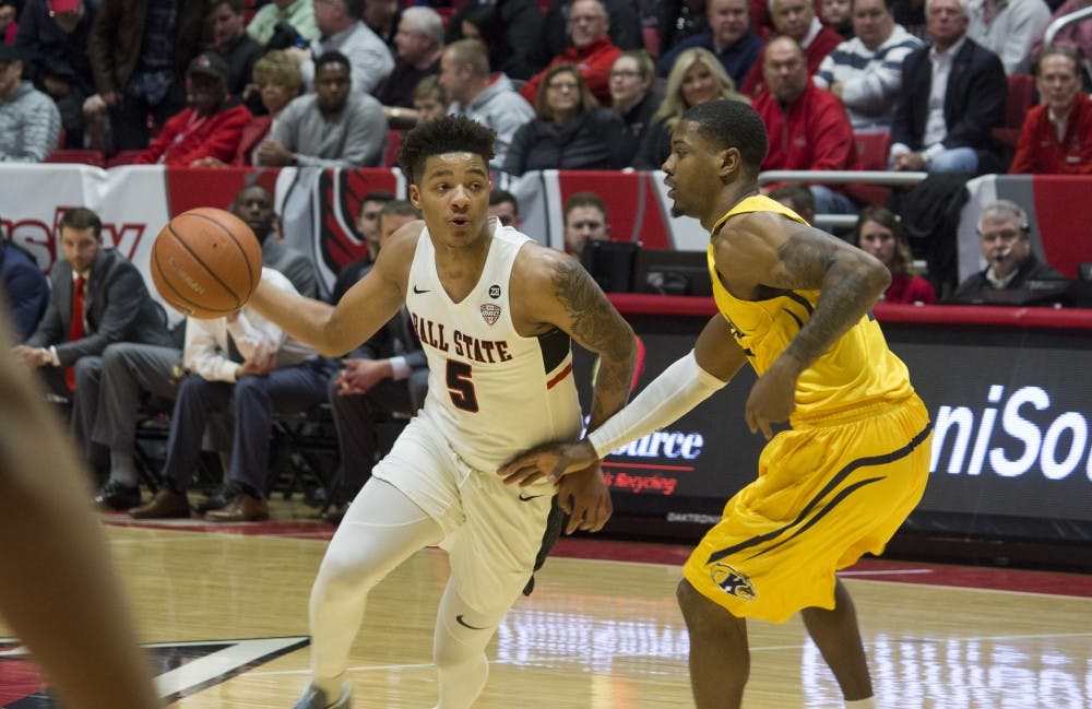 <p>Ball State men’s basketball player Ishmael El-Amin, 5, goes to pass around Kent State University player Desmond Ridenour, 32, during the first half of the game against Kent State Feb. 9 at John E. Worthen Arena. Ball State won the game 87-68. <strong>Briana Hale, DN</strong></p>