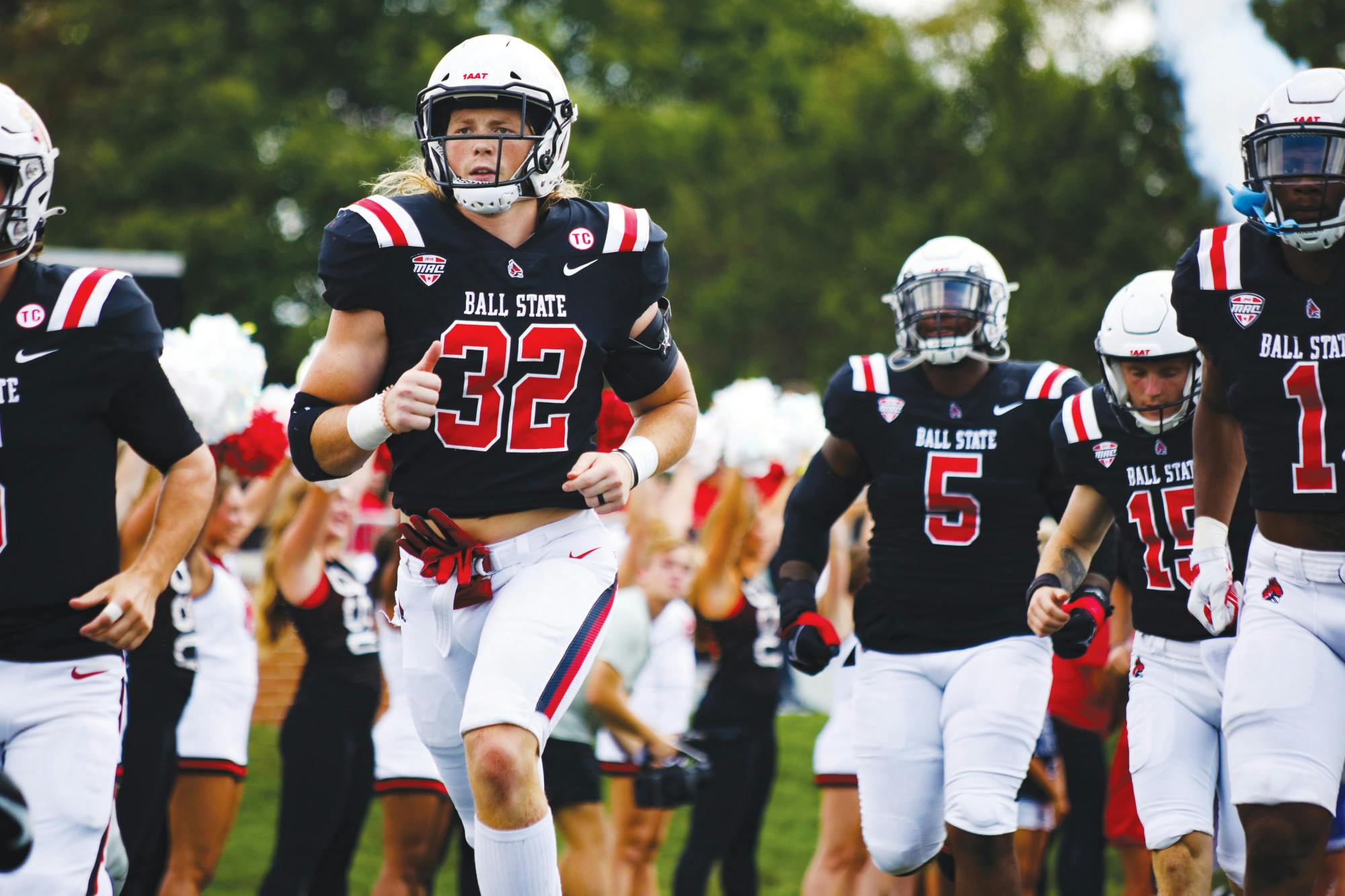 Senior linebacker Clayton Coll runs onto the football field before a game against Murray State Sept. 17, 2022 at Scheumann Stadium. Amber Pietz, DN