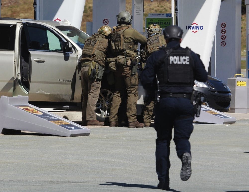 <p>Royal Canadian Mounted Police officers surround a suspect at a gas station in Enfield, Nova Scotia on Sunday April 19, 2020. Canadian police say multiple people are dead plus the suspect after a shooting rampage across the province of Nova Scotia. <strong>(Tim Krochak/The Canadian Press via AP)</strong></p>