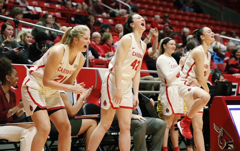 (left to right) Sophomore forward Blake Smith, freshman forward Annie Rauch and freshman guard Estel Puiggros celebrate on the sideline Feb. 19, 2020 at John E. Worthen Arena. Ball State won 97-89 against Northern Illinois. Katie Hawkins, DN