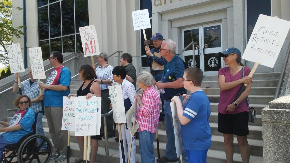 People attending the NAACP Muncie branch rally display signs to crowd for photos. The rally held May 18, 2019, at Muncie City Hall was to promote adding sex, gender, gender identity, and age to the Indiana Hate Crime Bill, House Bill 1020. Charles Melton, DN.&nbsp;