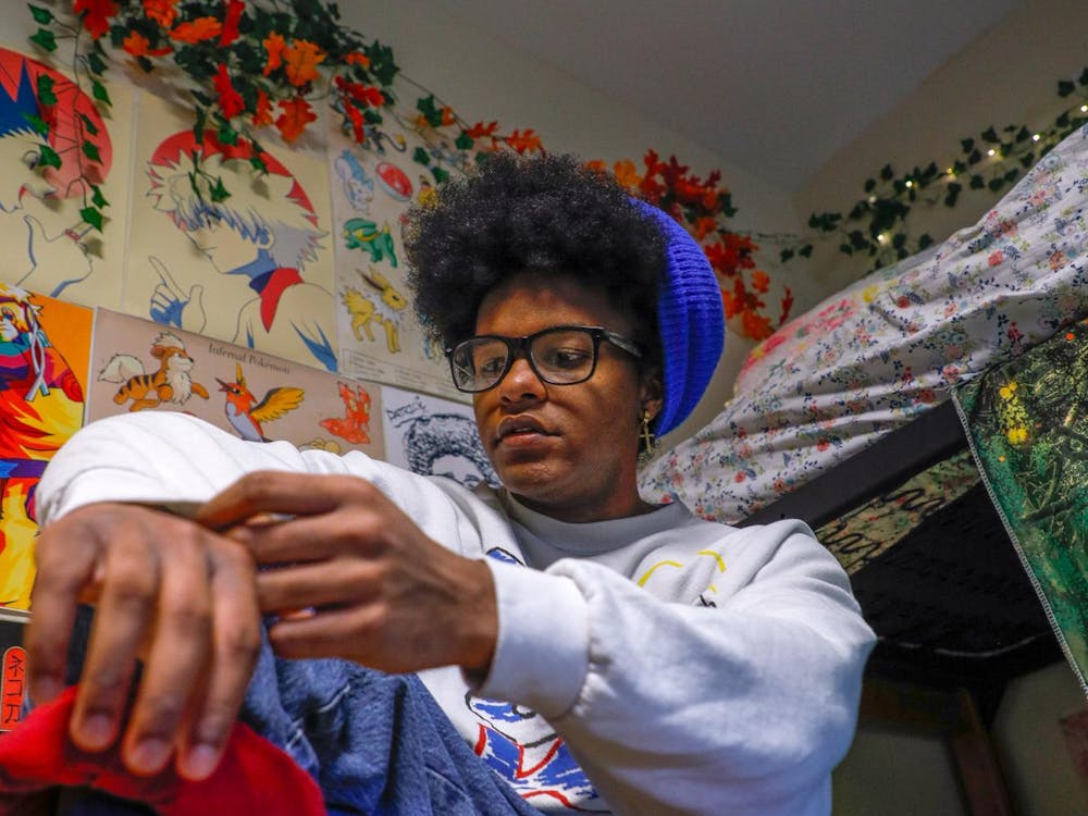 Second year fashion major Patrick Phillips poses wearing vintage clothing in their colorfully decorated room Nov. 27 at Park Hall. Andrew Berger, DN