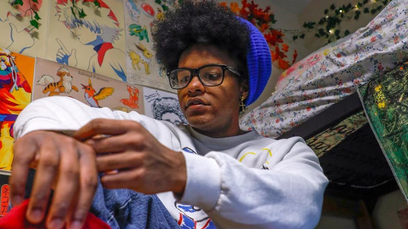 Second year fashion major Patrick Phillips poses wearing vintage clothing in their colorfully decorated room Nov. 27 at Park Hall. Andrew Berger, DN