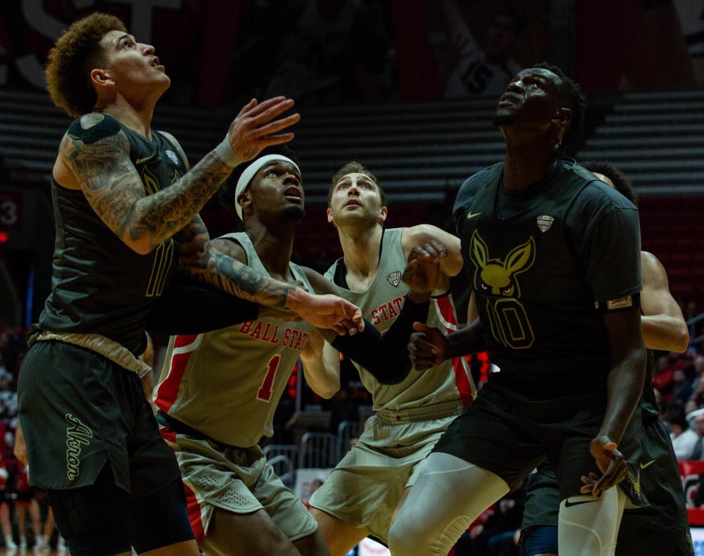 Redshirt junior guard K.J. Walton and redshirt sophomore forward Brachen Hazen attempt to get the ball during against Akron Feb. 16, 2019, in John E. Worthen Arena. Ball State defeated Akron 57-56. Scott Fleener, DN