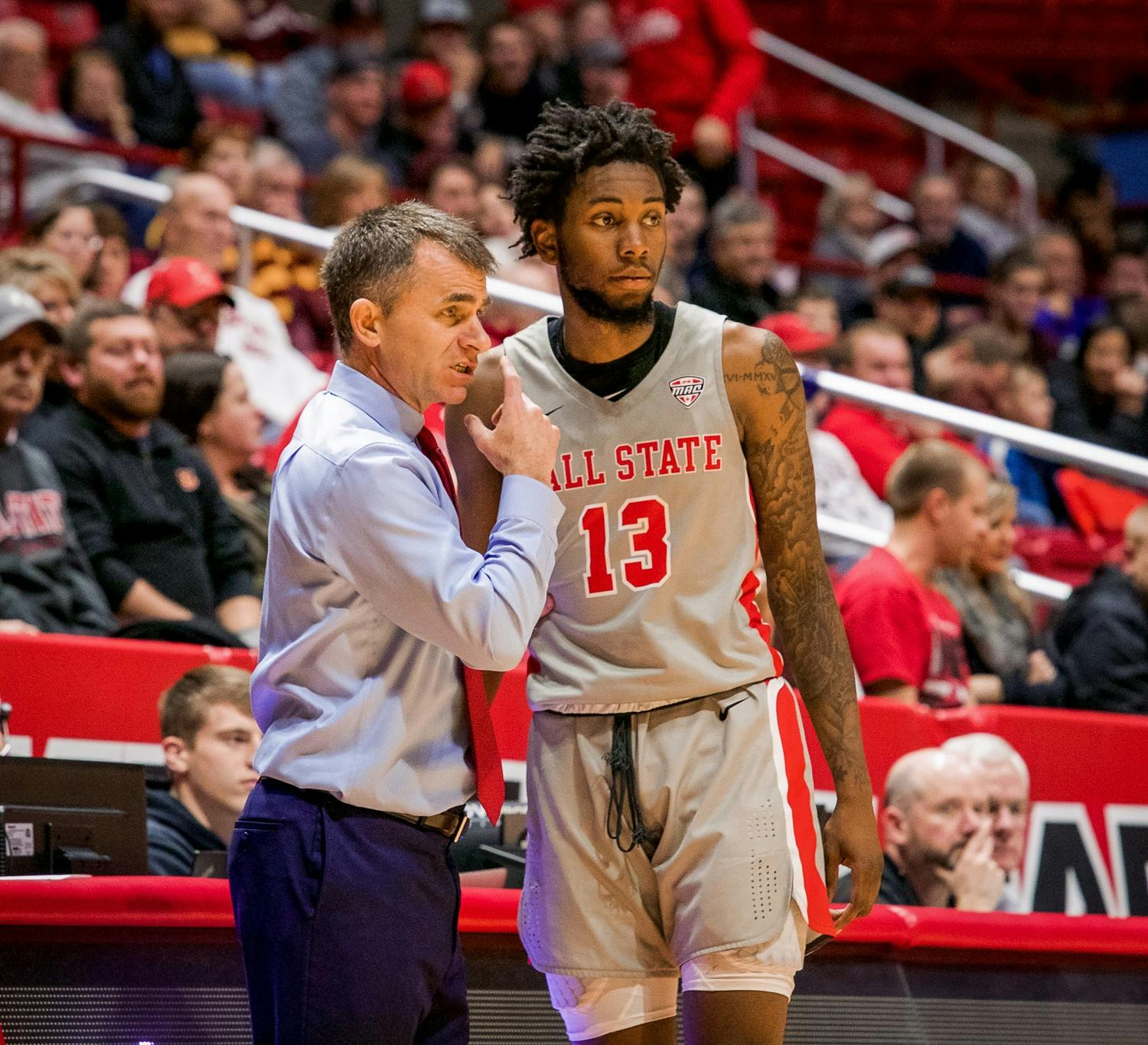 Head coach James Whitford talks with redshirt freshman guard/forward, Kani Acree (13), before entering the game late in the second half against Loyola Chicago Dec. 3, 2019, at John E. Worthen Arena. Acree played eight crucial minutes. Omari Smith, DN