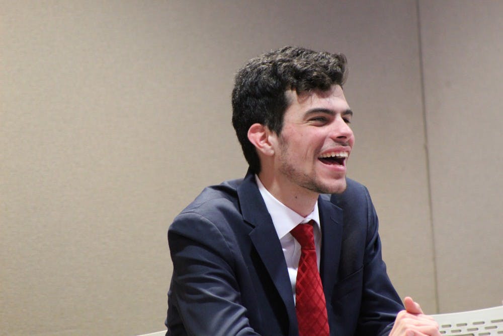 <p>Elected President Pro Tempore Carter Gallagher laughs at another senator's joke. &nbsp;Gallagher was voted by the senate to be next semester's president pro tempore at the senate meeting Wednesday, March 27 at the L.A. Pittenger Student Center. <strong>Charles Melton, DN</strong></p>