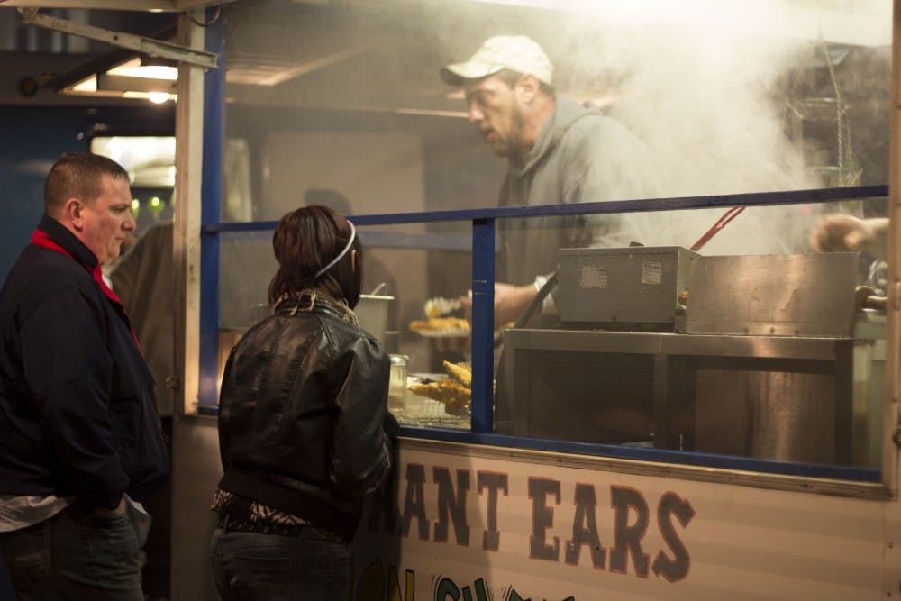 Food trucks and vendors lined the streets of downtown Muncie for the annual Muncie Gras. Choices ranged from giant elephant ears to chicken on a stick. DN PHOTO ROSS MAY