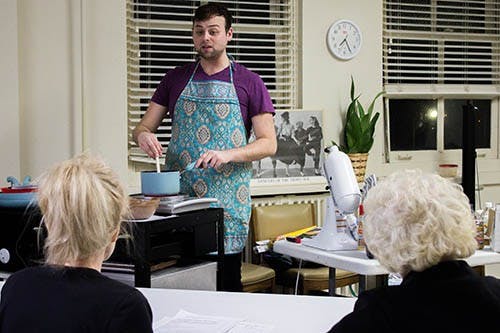 Derek O’neal answers questions while mixing ingredients over a hot plate. O’neal encourages participants to ask questions about the vegan lifestyle. DN PHOTO TAYLOR IRBY