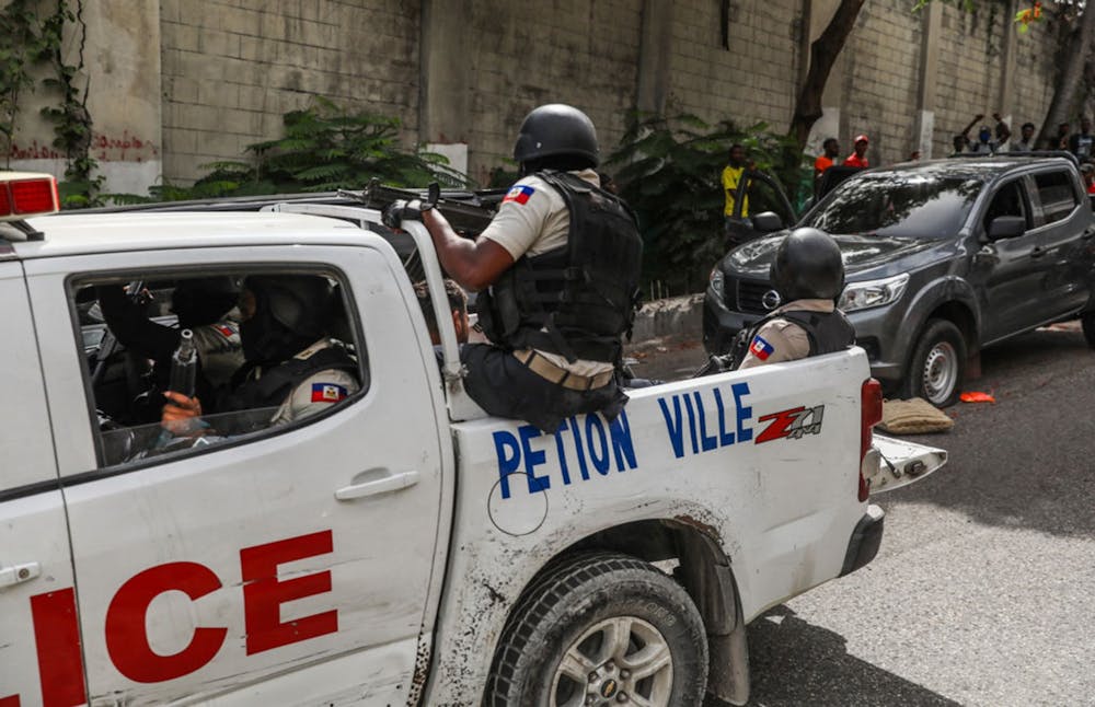 Two men accused of being involved in the assassination of Haiti President Jovenel Moise are transported to the Petion-Ville station in a police car in Port-au-Prince on July 8, 2021. (Valerie Baeriswyl/AFP via Getty Images/TNS)