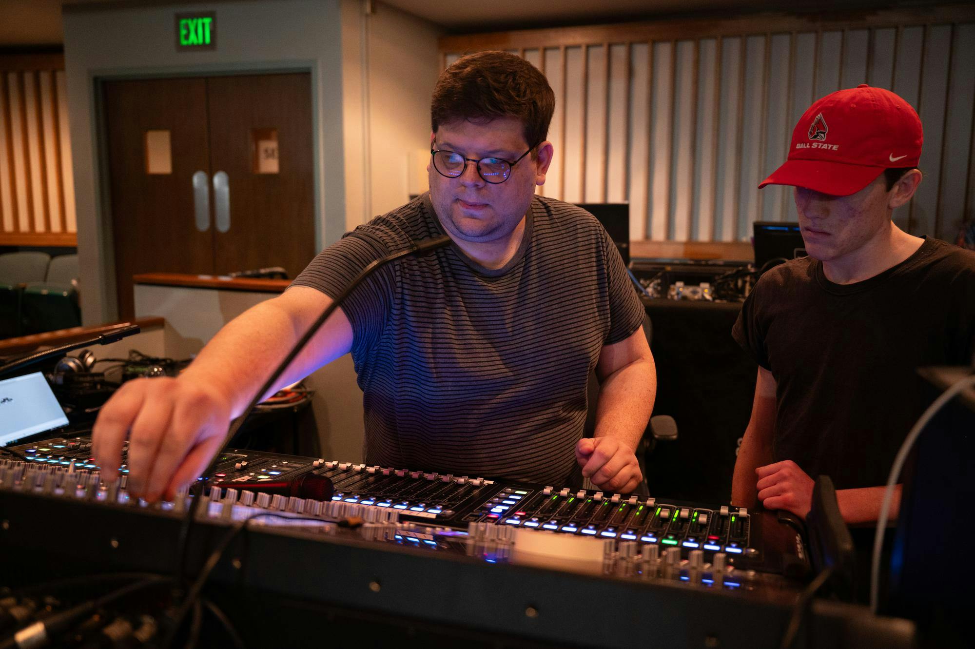 Brandon Reed, assistant professor of sound design, works with the sound board to adjust the sound of the pit musicians during rehearsal on March 15 for “Cats” in Emens Auditorium. Kadin Bright, Ball Bearings