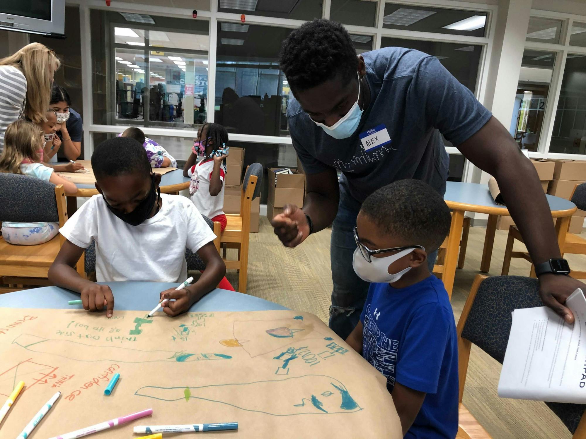 Alex Oleson, 2021 Orr Fellow for Woven, an Indianapolis based tech startup, talks with children participating in Launchpad to learn entrepreneurial skills. The Orr Fellowship matches students around the nation with Indianapolis-based companies for two-year fellowships. Erin Kelley, Photo Provided